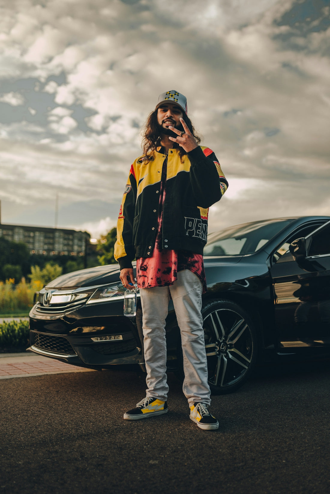 woman in black jacket and pants standing beside black car