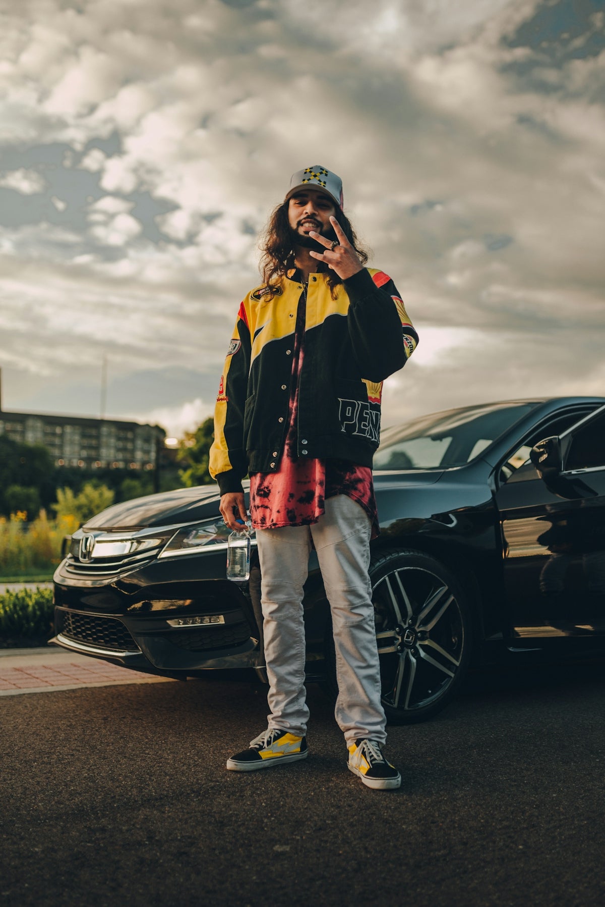 woman in black jacket and pants standing beside black car