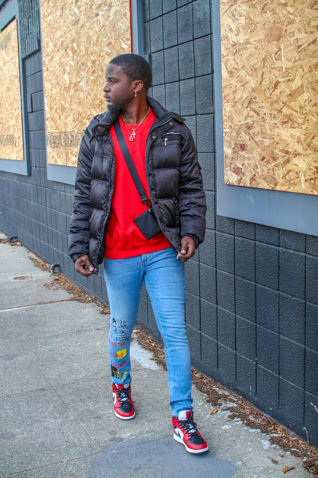 a man standing on a sidewalk next to a building