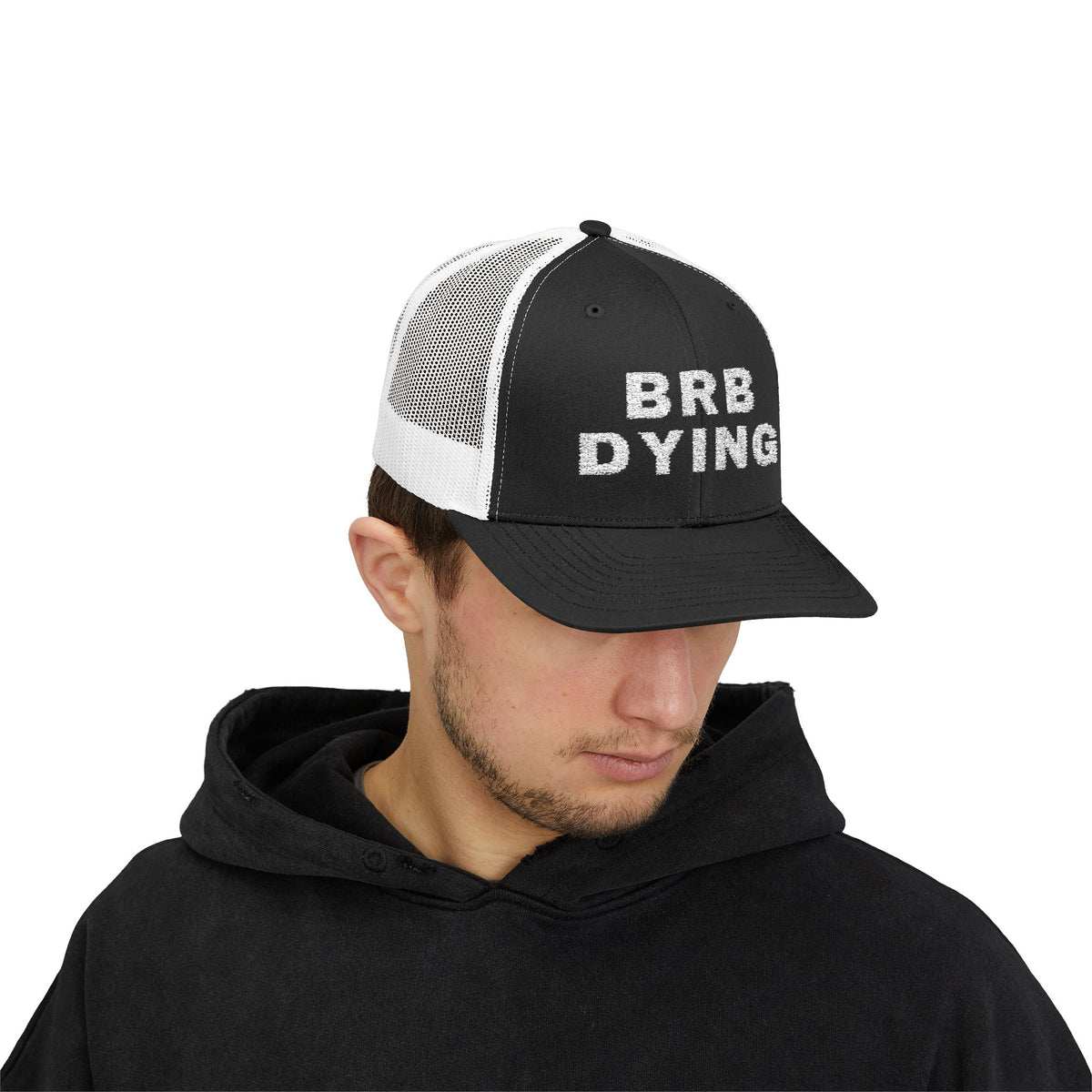 BRB DYING embroidered trucker cap in Black / White with white BRB DYING embroidery on the front – worn, front | Formless