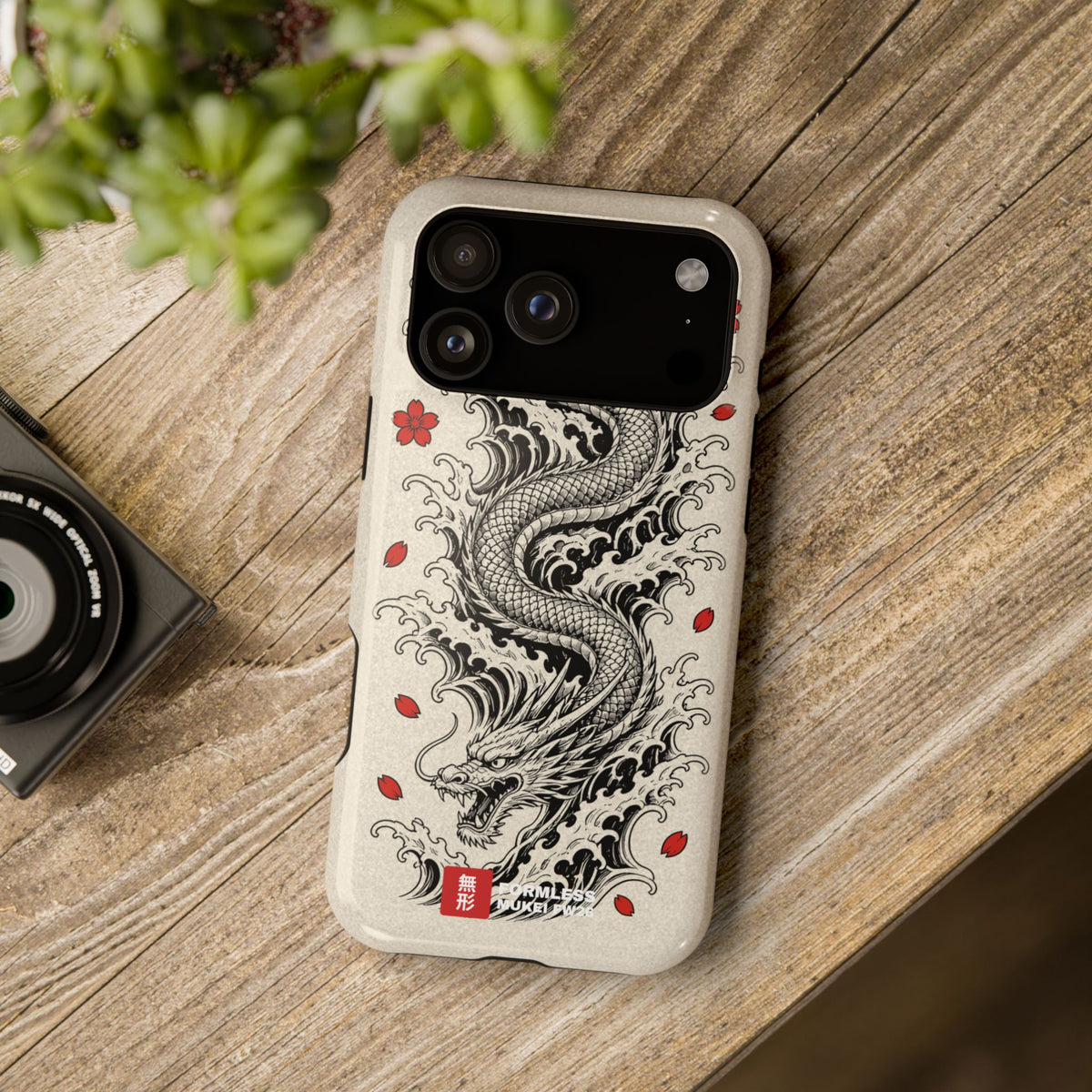 RYŪ dragon magnetic tough phone case in bone with black dragon and red sakura, on a wooden table | Formless
