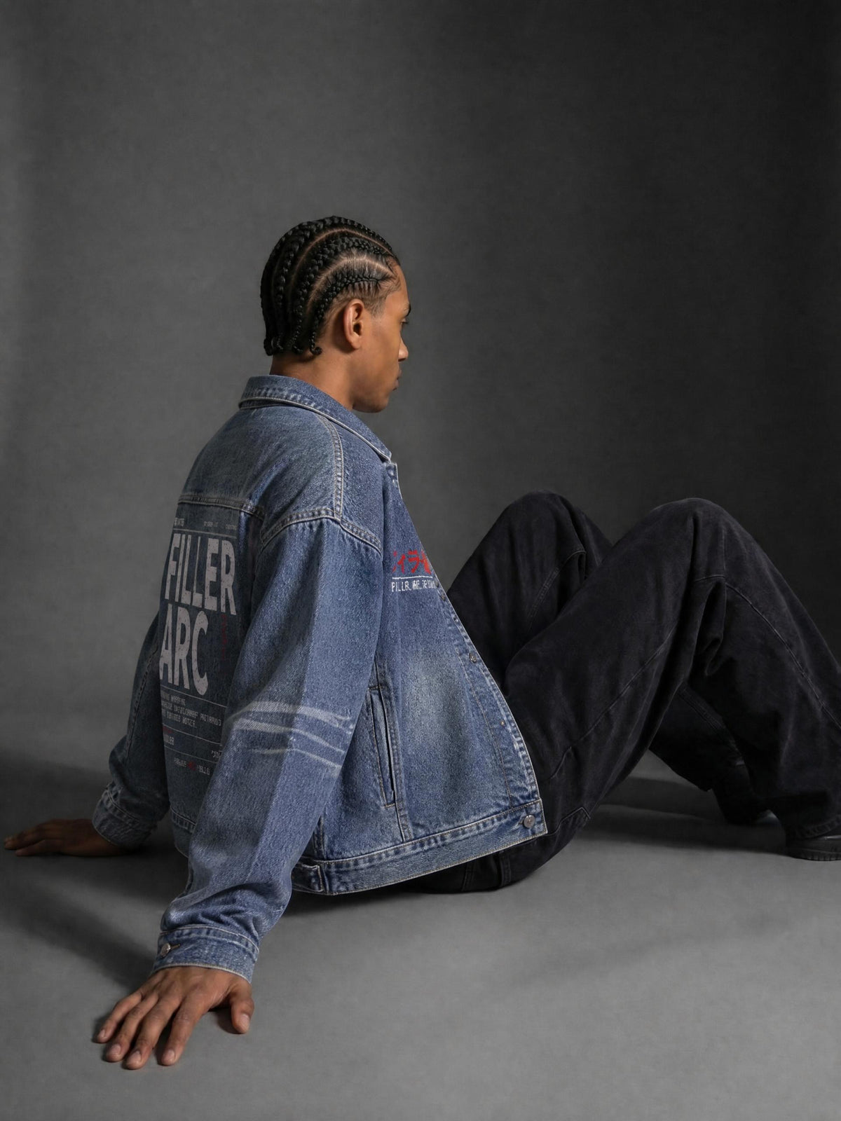 FILLER ARC vintage wash zip-up denim jacket in Blue, worn by a seated model, side view | Formless