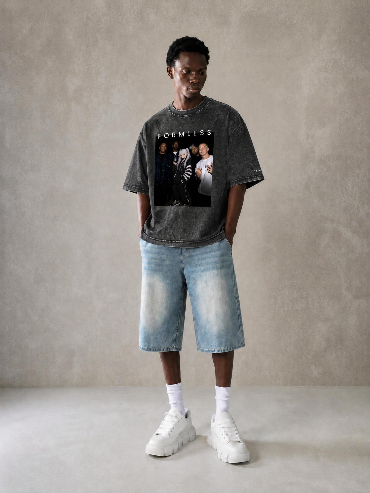 ALBUM mineral wash boxy tee in Black, worn by a model with light denim shorts, front view with photo graphic | Formless