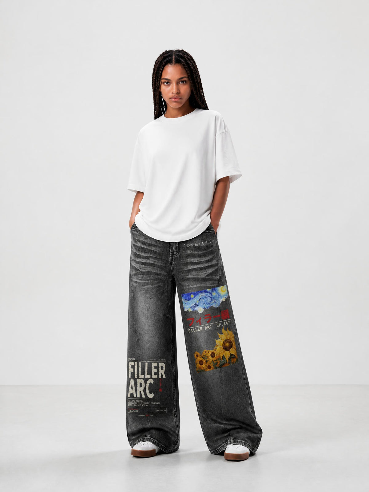 FILLER ARC women's vintage wash wide leg jeans in Black, worn by a model with a white tee, front view with printed thigh graphic | Formless