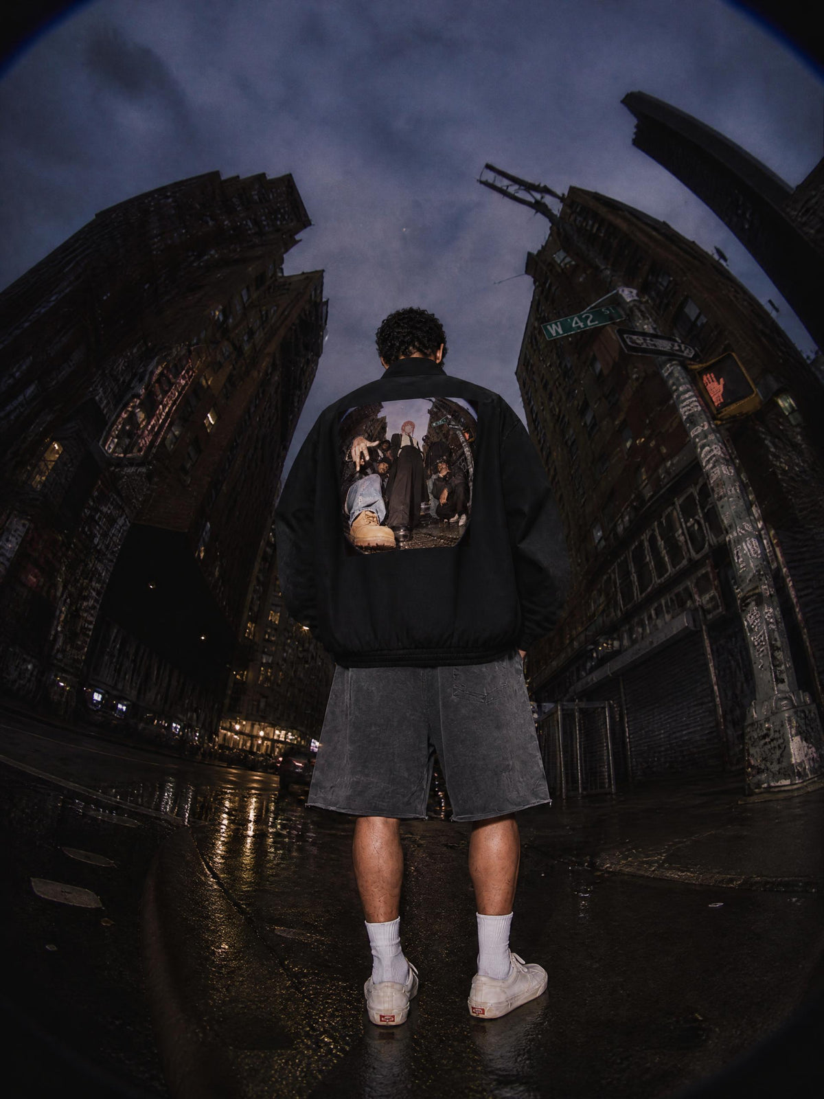Black stand collar bomber jacket worn by a model, back view with square photo graphic | Formless