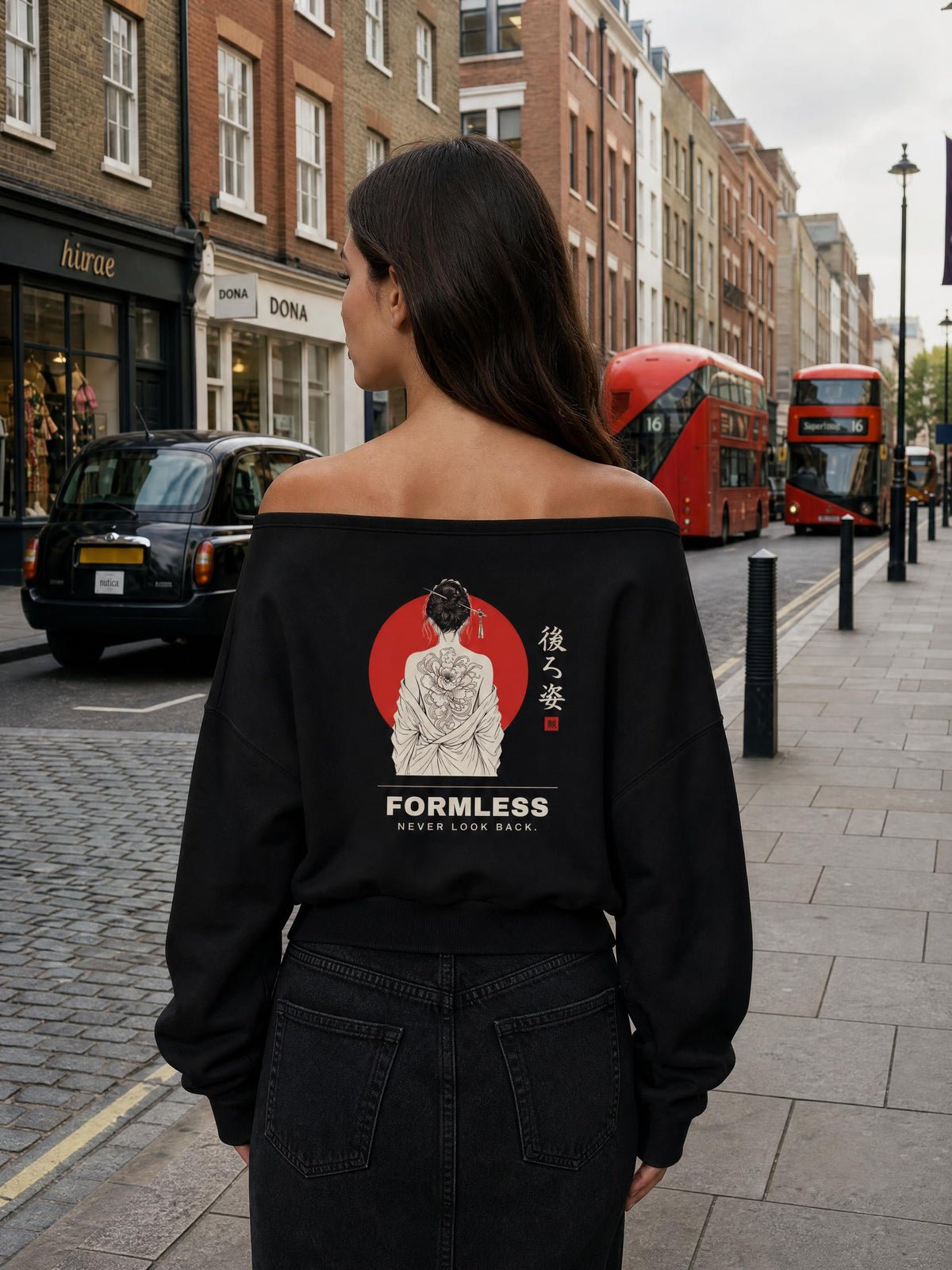 USHIROSUGATA off-shoulder sweatshirt in Black worn off the shoulders by a model on a city street, back view with red sun, peony tattoo figure and NEVER LOOK BACK print | Formless