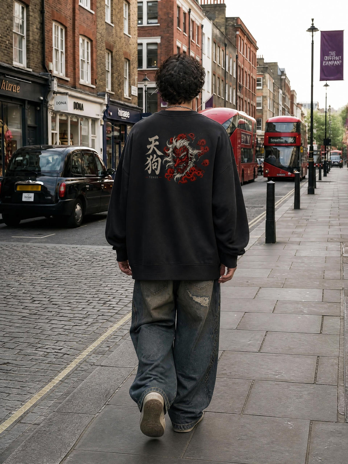 TENGU 天狗 distressed sweatshirt in Black worn by a model on a city street, back view with tengu mask and 天狗 print | Formless