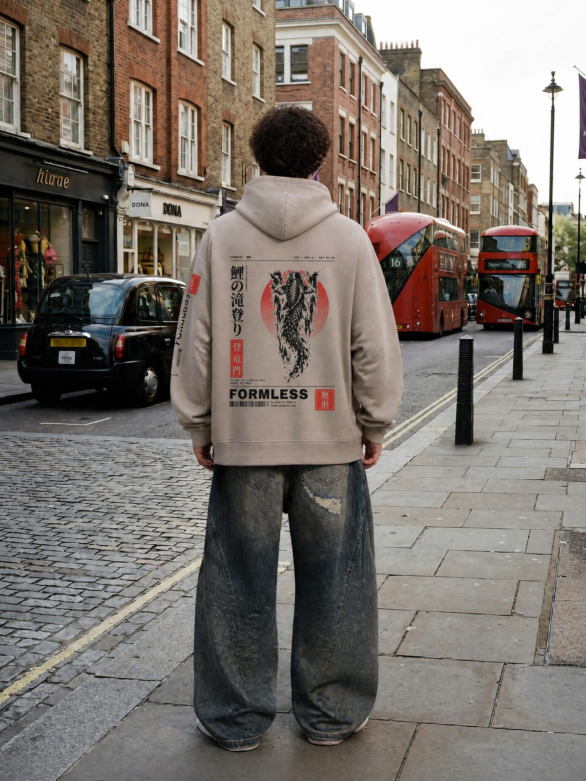 KOI heavyweight boxy hoodie in Medium Gray worn by a model on a city street, back view with koi, red sun and FORMLESS print | Formless