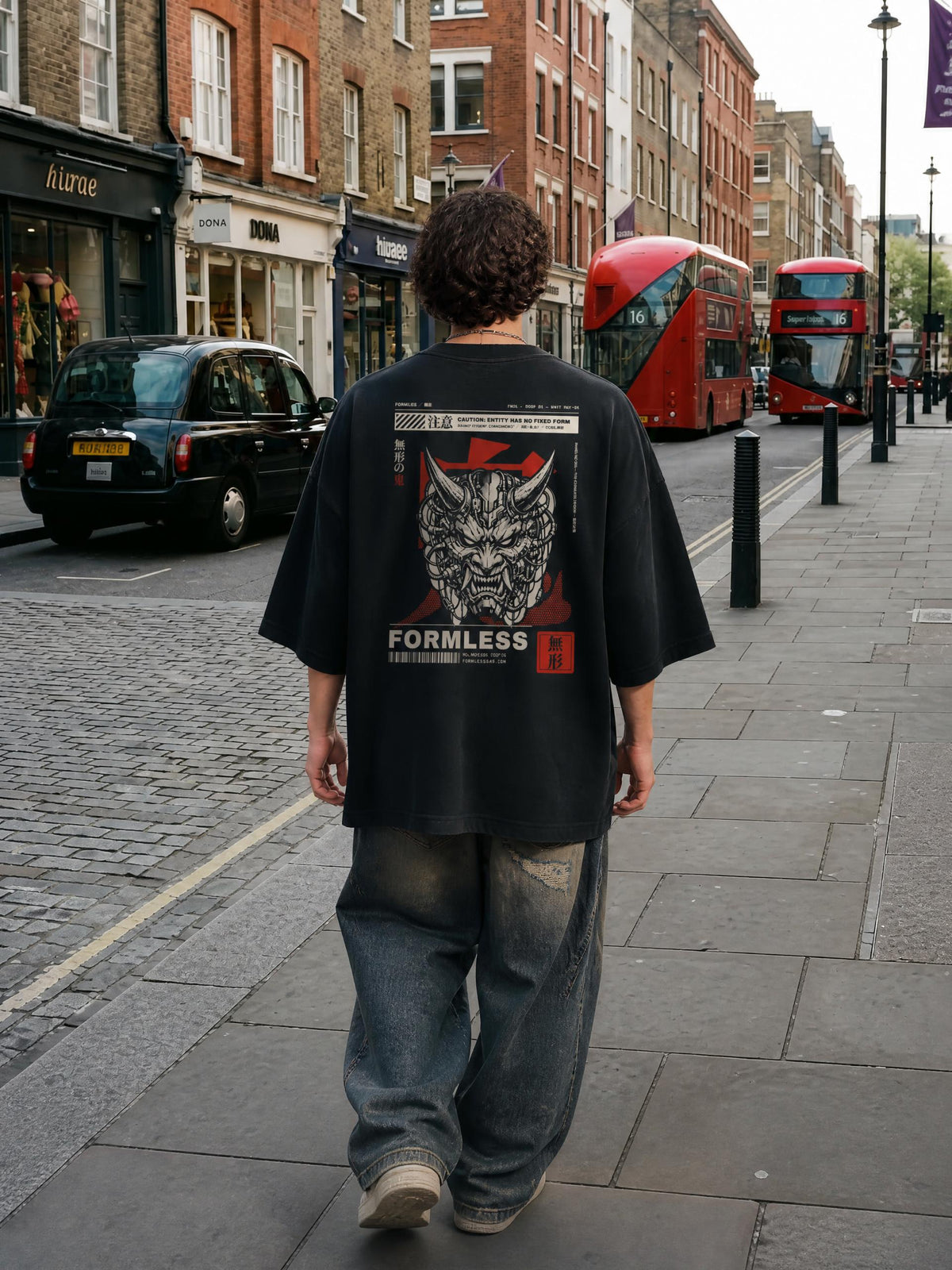 ONI heavyweight vintage washed frayed tee in Black worn by a model on a city street, back view with horned oni mask and FORMLESS print | Formless