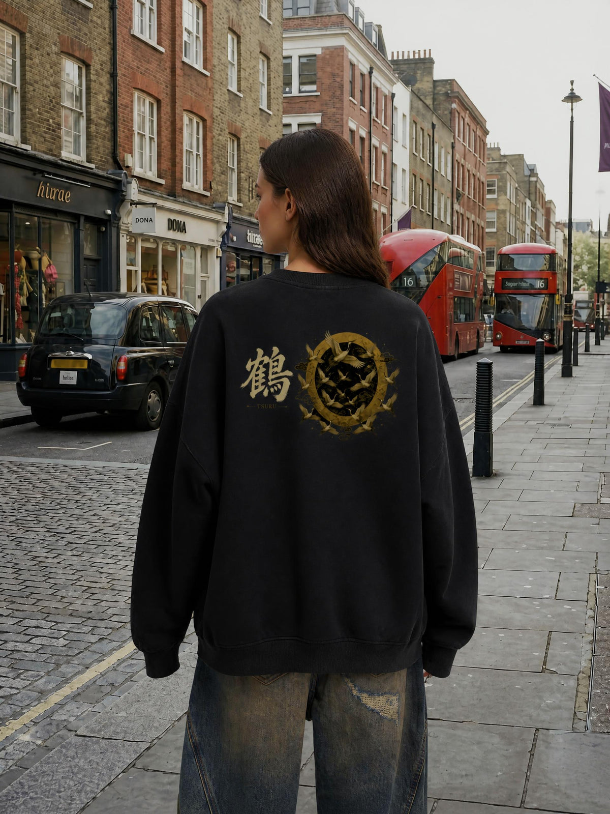 TSURU 鶴 distressed sweatshirt in Black worn by a model on a city street, back view with golden cranes and 鶴 print | Formless
